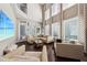 Spacious living room with soaring ceilings, large windows, and comfortable seating at 13890 Sato Ave, Orlando, FL 32827