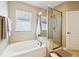 Beautiful bathroom featuring a soaking tub, separate shower, and bright natural light through window blinds at 13890 Sato Ave, Orlando, FL 32827