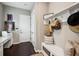 Inviting mud room area with a built-in bench, storage, coat rack, and a convenient desk area; perfect for organization at 13890 Sato Ave, Orlando, FL 32827