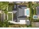 Expansive aerial view of a modern home with a black roof, landscaping, and inviting pool at 1400 Nottingham St, Orlando, FL 32803