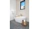 Elegant bathroom featuring a soaking tub and black-framed window that provides ample natural light at 1400 Nottingham St, Orlando, FL 32803