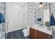 Stylish bathroom features navy blue patterned wallpaper and glass enclosed shower at 1400 Nottingham St, Orlando, FL 32803