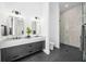 Modern bathroom with a double vanity, large mirrors, and a walk-in shower at 1400 Nottingham St, Orlando, FL 32803