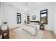 Modern bedroom featuring a plush bed, stylish decor, and abundant natural light from multiple windows at 1400 Nottingham St, Orlando, FL 32803