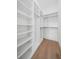 Walk-in closet featuring custom shelves and hanging rods at 1400 Nottingham St, Orlando, FL 32803