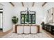 Bright dining room featuring a modern chandelier, wood beams, and a large window showcasing green views at 1400 Nottingham St, Orlando, FL 32803