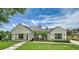 Stunning exterior showcasing a modern white home with a metal roof and lush landscaping at 1400 Nottingham St, Orlando, FL 32803