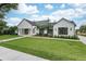 Eye-catching exterior view of a modern home with manicured lawn and a paver driveway at 1400 Nottingham St, Orlando, FL 32803