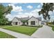 Modern home exterior with white brick, black metal roof, palm trees, and landscaped front yard at 1400 Nottingham St, Orlando, FL 32803