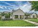 Beautiful exterior elevation of a white home featuring black trim, palm trees and green lawn at 1400 Nottingham St, Orlando, FL 32803