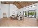 Open-concept living room featuring vaulted wood ceiling, electric fireplace and sliding doors to outdoor space at 1400 Nottingham St, Orlando, FL 32803