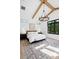 Bright primary bedroom featuring wood beams, large windows, a comfy bed, and decorative rug at 1400 Nottingham St, Orlando, FL 32803