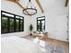 Bright primary bedroom featuring wood beams, large windows, seating area, and decorative rug at 1400 Nottingham St, Orlando, FL 32803