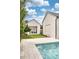 Angle view of the pool, the building with the sliding door open and the modern house with black trim at 1400 Nottingham St, Orlando, FL 32803