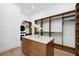 Spacious walk-in closet with a center island, custom shelving, and a washer/dryer set at 1400 Nottingham St, Orlando, FL 32803