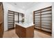 Walk-in closet with a white quartz island and extensive storage space for organization at 1400 Nottingham St, Orlando, FL 32803