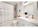 Bright bathroom with a shower-tub combo and white vanity at 1415 Sherbourne St, Winter Garden, FL 34787