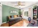 Comfortable bedroom with a daybed, desk, and green accent wall at 1415 Sherbourne St, Winter Garden, FL 34787