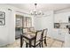 Dining area with a contemporary chandelier, neutral decor and sliding doors to the patio at 1415 Sherbourne St, Winter Garden, FL 34787