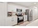 Bright kitchen with stainless steel appliances, white cabinets, and ample countertop space for meal preparation at 1415 Sherbourne St, Winter Garden, FL 34787