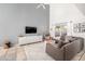 Bright living room featuring tile floors, a vaulted ceiling, and a large sectional sofa at 1415 Sherbourne St, Winter Garden, FL 34787