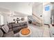Open-concept living room with tile flooring, a staircase, and flowing access to the kitchen at 1415 Sherbourne St, Winter Garden, FL 34787