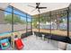 Spacious screened patio features a ceiling fan, outdoor seating, and a view of the backyard with a swing set at 1415 Sherbourne St, Winter Garden, FL 34787