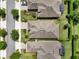 An aerial view of three homes featuring well-maintained landscaping and screened-in patios at 1424 Palisades Lane, Deland, FL 32724