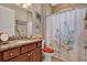 Bathroom features granite counters, vanity, shower curtain, and artwork at 1424 Palisades Lane, Deland, FL 32724