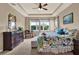 Bright bedroom features a floral bedspread, tray ceilings, ceiling fan and view of the backyard at 1424 Palisades Lane, Deland, FL 32724