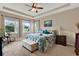 Inviting bedroom features a tray ceiling, soft lighting, and large windows offering plenty of natural light at 1424 Palisades Lane, Deland, FL 32724