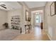 Welcoming foyer leading to a living area, featuring tile flooring and elegant decor at 1424 Palisades Lane, Deland, FL 32724