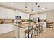 Modern kitchen with white cabinets, granite countertops, large island and pendant lighting at 1424 Palisades Lane, Deland, FL 32724