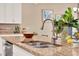 Close-up shot of the kitchen island featuring a stainless steel sink and modern faucet at 1424 Palisades Lane, Deland, FL 32724