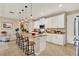Bright kitchen boasts white cabinets, a center island with bar stool seating, and a neutral color scheme at 1424 Palisades Lane, Deland, FL 32724