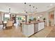 Open-concept kitchen features stainless steel appliances, a center island, and easy access to dining and living spaces at 1424 Palisades Lane, Deland, FL 32724