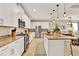 Modern kitchen with stainless steel appliances, white cabinets, and a spacious granite island at 1424 Palisades Lane, Deland, FL 32724