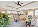 Spacious living area shows open floorplan to kitchen, tray ceiling, and comfortable seating at 1424 Palisades Lane, Deland, FL 32724