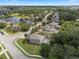 Scenic neighborhood view, featuring lush landscaping, a tranquil pond with fountain and well-kept homes at 14315 Hampshire Bay Cir, Winter Garden, FL 34787