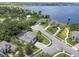 Expansive aerial view of homes on manicured lawns, with lakeside access and a private dock at 14315 Hampshire Bay Cir, Winter Garden, FL 34787