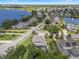 Aerial view of neighborhood homes near a lake featuring manicured lawns and mature trees, creating a serene setting at 14315 Hampshire Bay Cir, Winter Garden, FL 34787