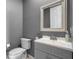 Stylish half bathroom with gray walls, modern fixtures, and a clean design at 14315 Hampshire Bay Cir, Winter Garden, FL 34787