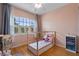 bedroom featuring pink walls, a window with shutters, hardwood floors, and a cute, small bed at 14315 Hampshire Bay Cir, Winter Garden, FL 34787