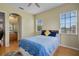 Bright bedroom featuring wood floors, multiple windows, and an en-suite bathroom, providing a comfortable and private retreat at 14315 Hampshire Bay Cir, Winter Garden, FL 34787