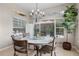 Sunlit dining area featuring a chandelier, a round table and a view of the backyard at 14315 Hampshire Bay Cir, Winter Garden, FL 34787