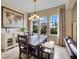 Bright dining room featuring a rustic wood table and ample natural light at 14315 Hampshire Bay Cir, Winter Garden, FL 34787