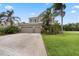 Well-maintained two-story home with an attached three-car garage and mature palm trees at 14315 Hampshire Bay Cir, Winter Garden, FL 34787