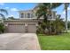 Inviting two-story home featuring a brick driveway and a three-car garage at 14315 Hampshire Bay Cir, Winter Garden, FL 34787