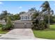 Two-story home featuring a three-car garage and manicured landscaping at 14315 Hampshire Bay Cir, Winter Garden, FL 34787