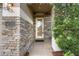 The front entrance has brick veneer, a glass door, and a side light at 14315 Hampshire Bay Cir, Winter Garden, FL 34787